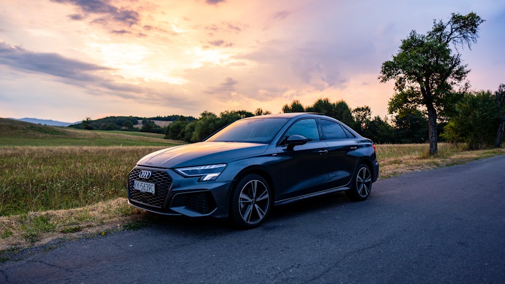 Audi car parked on a countryside road in Slovakia during a picturesque sunset.